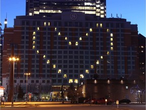 The Sheraton Eau Claire displays a heart symbol at sunset in downtown Calgary on  Tuesday, April 21, 2020. Every night at sunset the popular downtown hotel lights up part of the skyline.