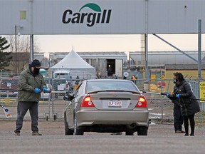 Union members hand out masks and information to workers entering the Cargill plant near High River while protesting the meat processing plant reopening on Monday, May 4, 2020.