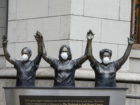 Surgical masks placed on a statue outside Princess Margaret Hospital in Toronto on March 19, 2020.