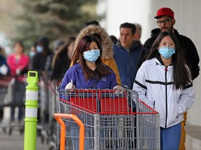 Shoppers wait in line to enter Costco in Sunridge on Sunday, May 10, 2020.