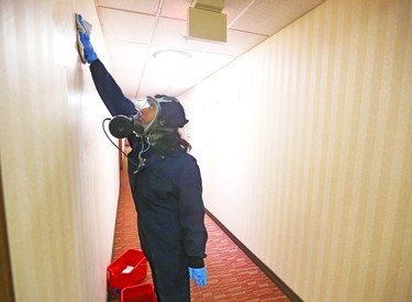 A member of the cleaning staff scrubs a wall at the assisted self isolation hotel in Calgary on Thursday, May 7, 2020. Postmedia has agreed not to reveal the exact location of the hotel. Jim Wells/Postmedia