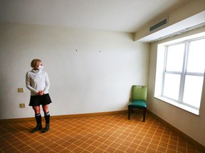 Dr Kerri Treherne looks out a window of a stripped-down room at the assisted self-isolation hotel in Calgary on Thursday, May 7, 2020. The facility is one many innovations from Calgary's social services agencies.