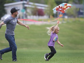 Before the afternoon rain hit Calgary, Justin Gaulin flies a kite with his daughter Riley 6 yrs in Stanley Park in Calgary on Sunday, May 31, 2020.