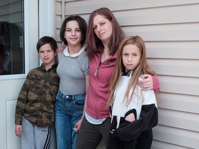 Sarah Sansom and her children, from left to right, Addison, 11, Ceirra, 13, and Daylen 8, pose for a portrait at their home in Nobleford, Alta., on Friday, May 29, 2020. Sarah's husband, and the children's father Jacob (Jake) Sansom and his uncle Morris Cardinal were found shot to death on a rural road in eastern Alberta in March 2020. Anthony Michael Bilodeau, 31, has been charged with two counts of second-degree murder over the deaths of Sansom and Cardinal.