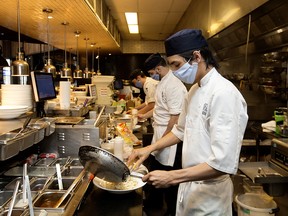 Chefs work the dinner rush at Earls Tin Palace in Edmonton Wednesday, May 20, 2020.