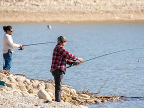 People try their luck fishing on the Glenmore Reservoir on Wednesday, May 6, 2020. The reservoir is currently closed to  watercraft due to the COVID-19 pandemic.