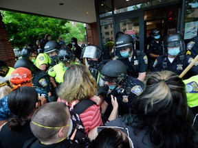 Protesters and police officers clash outside District Four Police station during a demonstration against police brutality and racism in the US, with the recent deaths of George Floyd, Ahmaud Arbery, Breonna Taylor, in Boston, Massachusetts, on May 29, 2020.