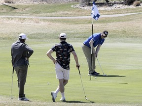 Golfers are seen enjoying the links for the first time this season at Fox Hollow Golf Course in Calgary on Saturday, May 2, 2020.