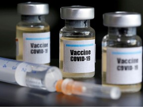 Small bottles labeled with a "Vaccine COVID-19" sticker and a medical syringe are seen in this illustration taken taken April 10, 2020.