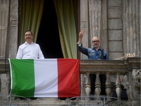 Mayor of Milan Giuseppe Sala and guitarist Saturnino sing anti-fascist song "Bella Ciao" on the balcony of Palazzo Marino on Liberation Day following the outbreak of the coronavirus disease (COVID-19) in Milan, Italy, April 25, 2020. REUTERS/Daniele Mascolo ORG XMIT: AI