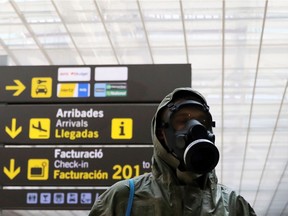 A passenger wearing protective garments arrives at the Josep Tarradellas Barcelona-El Prat Airport, after the Spanish government announced that from May 15th all people entering the country will have to go under quarantine for two weeks, amid the coronavirus disease (COVID-19) outbreak, in Barcelona, Spain, May 15, 2020.