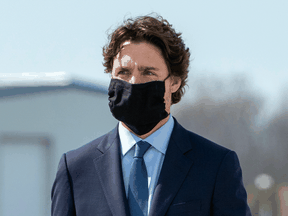 Prime Minister Justin Trudeau wears a protective face mask as he attends a repatriation ceremony at CFB Trenton for the six Canadian Forces personnel killed in a military helicopter crash, May 6, 2020.