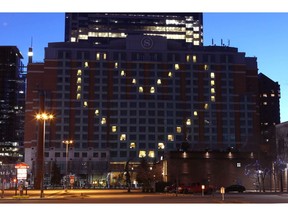 The Sheraton Eau Claire displays a heart symbol at sunset in downtown Calgary. Every night at sunset, the popular downtown hotel lights up part of the skyline. Jim Wells/Postmedia