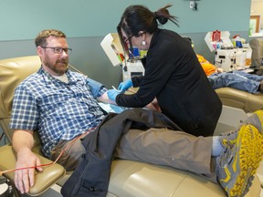 A man donates plasma at a Canadian Blood Services centre in London, Ont.