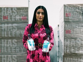 Manjit Minhas, co-founder and chief executive officer of Minhas Breweries and Distillery, with some of the hand sanitizer they have produced. The company has donated more than 100,000 bottles of the cleaner.