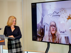 NDP Leader Rachel Notley speaks with Kirsten Proulx, owner of Henry’s Interiors in Edmonton, at a news conference on Thursday, May 21, 2020, calling for help from the province.