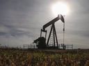 A pumpjack works on a wellhead at an oil and gas facility near Cremona, Alta.