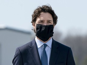 Prime Minister Justin Trudeau wears a mask at a repatriation ceremony for the six Canadian Armed Forces members killed in a helicopter crash off of Greece during Operation Reassurance, at CFB Trenton, Ont. on Wednesday, May 6, 2020. Trudeau says a national recommendation on when and where Canadians should be wearing face masks is coming later today.