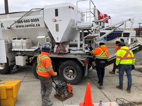 Workers get set to pour cement from a truck at the GO train station in Oakville, Ont., Tuesday, Jan.28, 2020. Statistics Canada is set today to report how many workers lost their jobs in April or had their hours slashed as a result of the COVID-19 pandemic.THE CANADIAN PRESS/Richard Buchan