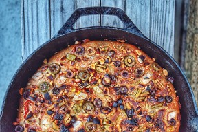 A yeasted spelt focaccia topped with olives, peppers, garlic and almonds.