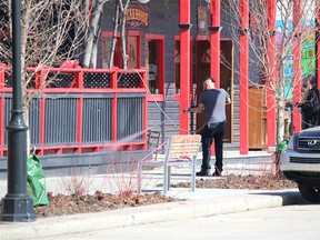 Texas Gate Bar & Grill staff clean up the establishment’s outdoor seating area on May 13.