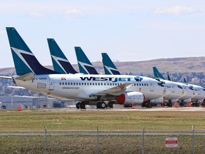 Idled WestJet planes fill an unused runway at the Calgary International Airport on Tuesday, May 5, 2020.