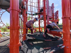 Schona Mrozek sanitizes the playground equipments for her two-year-old son Tyson to play in the playground in East Village on Friday, May 29, 2020.