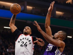 Toronto Raptors guard Norman Powell, left, goes to the basket against Sacramento Kings forward Harry Giles III, right, during the first quarter of an NBA basketball game in Sacramento, Calif., Sunday, March 8, 2020.