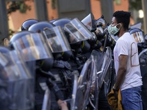 Demonstrators confront law enforcement during a protest on June 1, 2020 in downtown Washington, DC. Protests and riots continue in cities across America following the death of George Floyd, who died after being restrained by Minneapolis police officer Derek Chauvin. Chauvin, 44, was charged last Friday with third-degree murder and second-degree manslaughter.