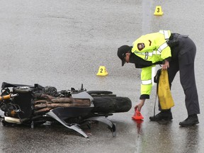 Calgary Police investigate at the scene of a fatal motorcycle accident on Stoney Trail NW in Calgary on Saturday, June 27, 2020. Police say the accident took place around 3 p.m. on northbound Stoney Trail between Scenic Acres Link and Crowchild Trail in Calgary's northwest.