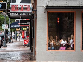 A group of women have lunch at a restaurant in Austin, Texas, June 26, 2020. - Texas Governor Greg Abbott ordered bars to be closed by noon on June 26 and for restaurants to be reduced to 50% occupancy. Coronavirus cases in Texas have spiked in recent weeks after being one of the first states to begin reopening.