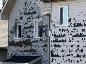 The aftermath of Saturday's intense hail storm shows in damaged homes in Saddle Ridge in northeast Calgary.