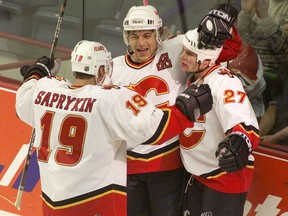 Calgary Flames Oleg Saprykin, Jarome Iginla, and Marc Savard celebrate a goal on Dec. 7, 2000.
