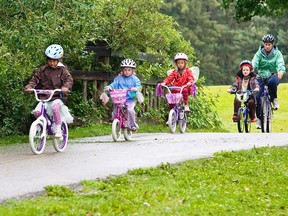 Children ride in a cycling day camp in Calgary in 2009. The city's day camps will be run entirely outside this year due to the COVID-19 pandemic.