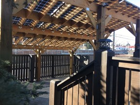 Solar panels on a pergola shade a patio built above a garage in Southland providing energy for charging electric vehicles, powering a home and even sending energy to the grid.