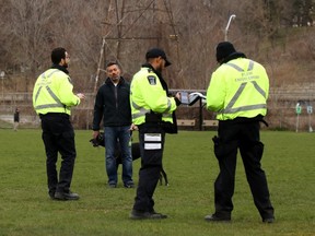 Toronto bylaw officers hand a man a $750 ticket under anti-COVID-19 rules for having his dog off-leash in a park on Friday, April 24, 2020.
Some jurisdictions are too quick to issue tickets, says columnist Danielle Smith. It's time to stop unreasonable restrictions on our freedoms.