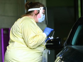 Heathcare staff take samples at a fast track assessment centre in southwest Calgary on Tuesday, June 2, 2020.