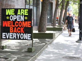 A sign for Another Dimension Comics on 10 St NW welcoming back shoppers is shown on  Friday, June 5, 2020 near the Kensington neighbourhood.