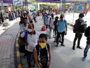 Passengers stand in a queue outside a railway station to board a train after a few restrictions were lifted during an extended nationwide lockdown to slow the spread of the coronavirus disease (COVID-19), in New Delhi, India, June 1, 2020.