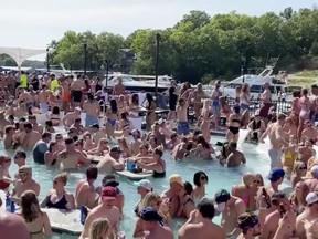 Revelers celebrate Memorial Day weekend at Osage Beach of the Lake of the Ozarks, Missouri, U.S., May 23, 2020 in this screen grab taken from social media video and obtained by Reuters on May 24, 2020. THIS IMAGE HAS BEEN SUPPLIED BY A THIRD PARTY. MANDATORY CREDIT. NO RESALES. NO ARCHIVES. ORG XMIT: USA001