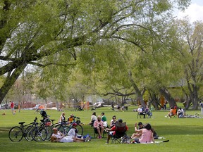 People enjoy a recent sunny day in Riley Park in Calgary.