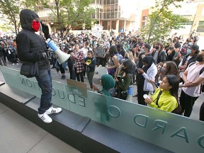 Anti-racism protesters gather in front of the Calgary Board of Education headquarters in downtown Calgary on Friday, June 19, 2020.