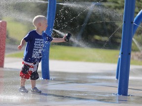 Carson Reid, 3, plays at the South Glenmore spray park in S.W. Calgary on Monday, July 20, 2015.