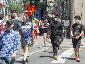 A busy Ste. Catherine street on Thursday, June 18, 2020 in Montreal. Many Montrealers are still not wearing face masks as the government strongly recommends.