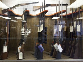Hunting rifles are seen on display in a glass case at a gun and rifle store in downtown Vancouver, Wednesday, Sept. 15, 2010. As the government prepares new gun-control legislation, a victims group says magazine capacity should be limited to five bullets for all firearms to reduce the potential damage a mass shooter can do.