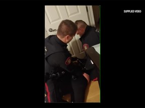 A still frame taken from a video Tara Yaschuk's son recorded of her being arrested by two Calgary Police Service officers. Yaschuk is alleging the officers used excessive force and assaulted her. She has filed a complaint under the Police Act and is requesting charges be laid against the officers.