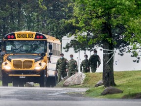 Canadian soldiers prepare to board a bus outside of the Altamonte Care Community in Scarborough, Ontario during the Covid 19 pandemic, Thursday May 28, 2020.