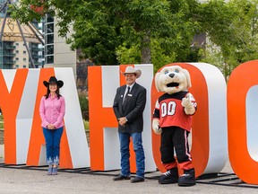Karen Young, United Way of Calgary and area president and CEO, left, and Dana Peers, Stampede Board president and chairman, and Gordie the dog pose for a photo at Stampede Park on Tuesday, July 7, 2020.