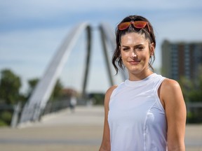 Jessica Chawrun poses for a photo on the Riverwalk on Thursday, July 16, 2020. Chawrun who has recovered from COVID-19 is running a half-marathon this weekend.