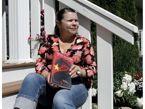 Author Karen Patterson poses with her book, Taking on China, How I Freed My Husband from Jail, outside her home on July 10, 2020. Brendan Miller/Postmedia